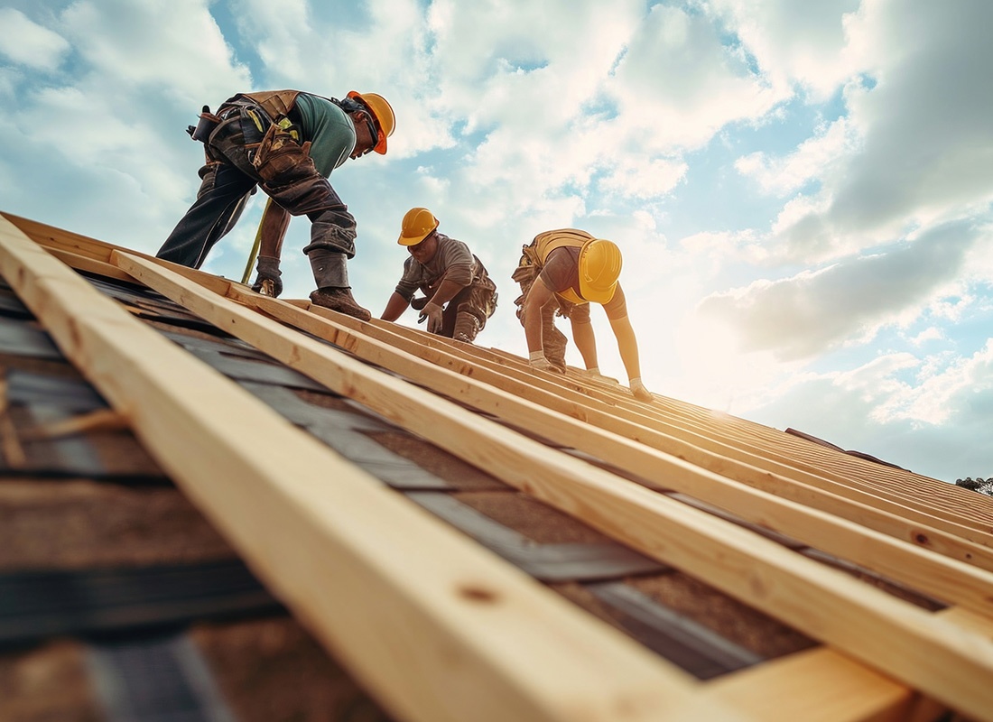 Insurance by Industry - Group of Three Male Contractors Working on Building a New Roof with a Cloudy Sky in the Background